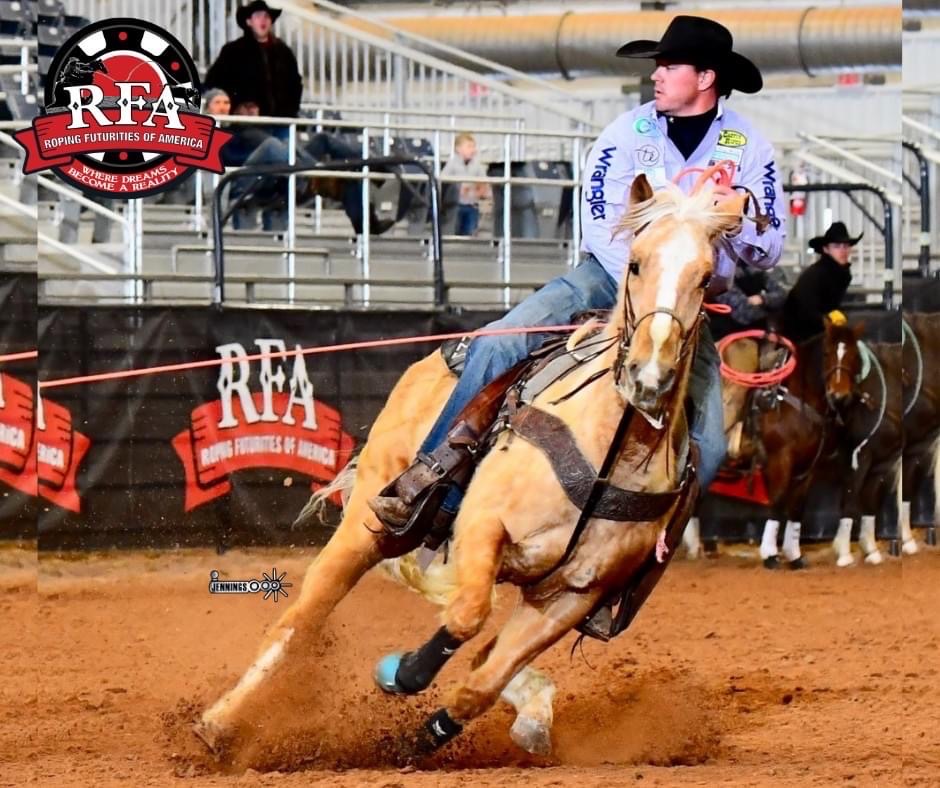 Barrel racer on palomino horse charging around barrel at RFA rodeo event, dirt arena with spectators in background