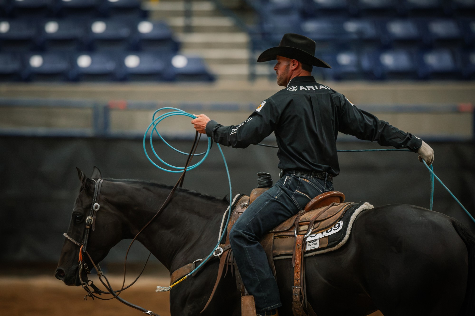 Miles Baker coils his rope while sitting on Fendiii, back number 3169, in the Amarillo arena.