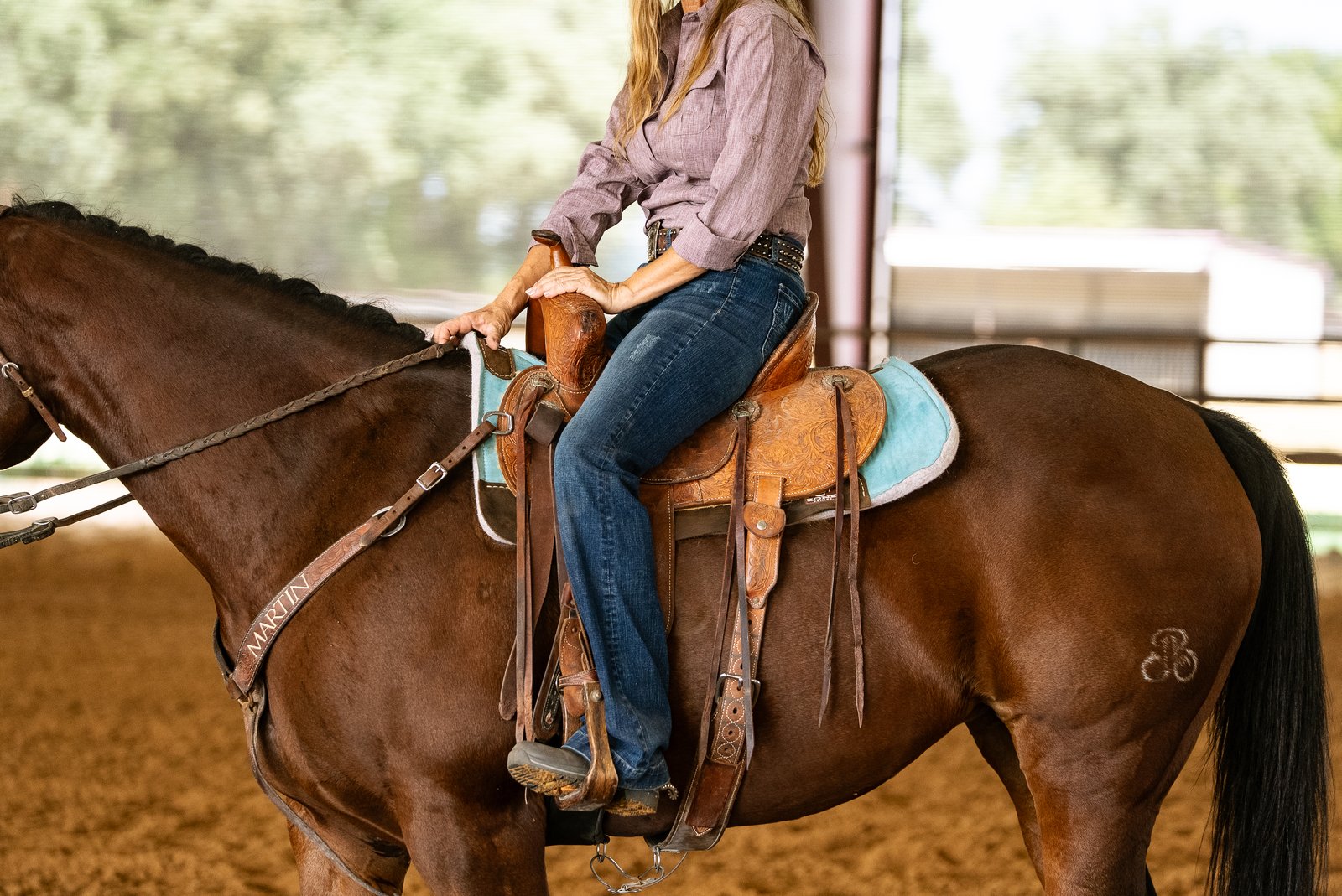 Kimmi Byler seated in a Martin FX3 barrel saddle on a bay horse